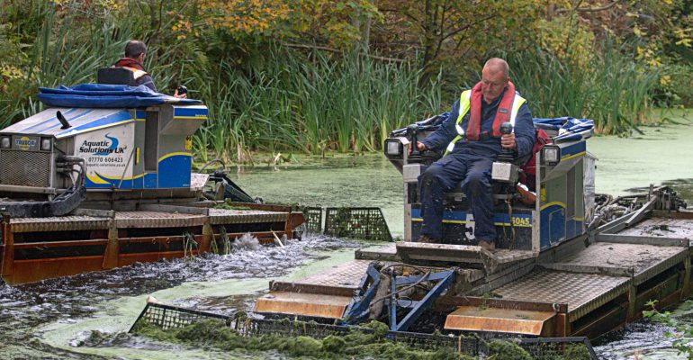 weed boats at work on The Bury to Bolton Canal